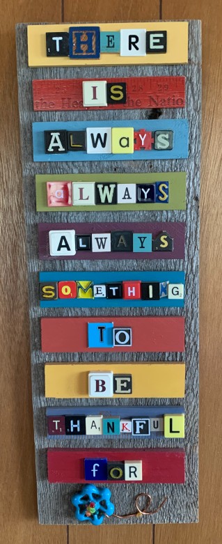 The author's mom's sign uses board game tiles to spell out the message "There is always, always, always something to be thankful for"