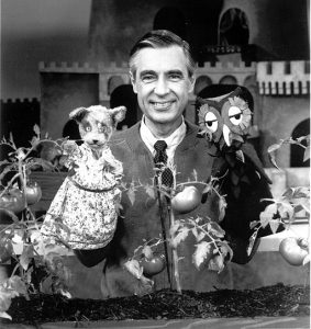 Fred Rogers on the set of Mr. Rogers' Neighborhood with puppets Henrietta Pussycat and X the Owl