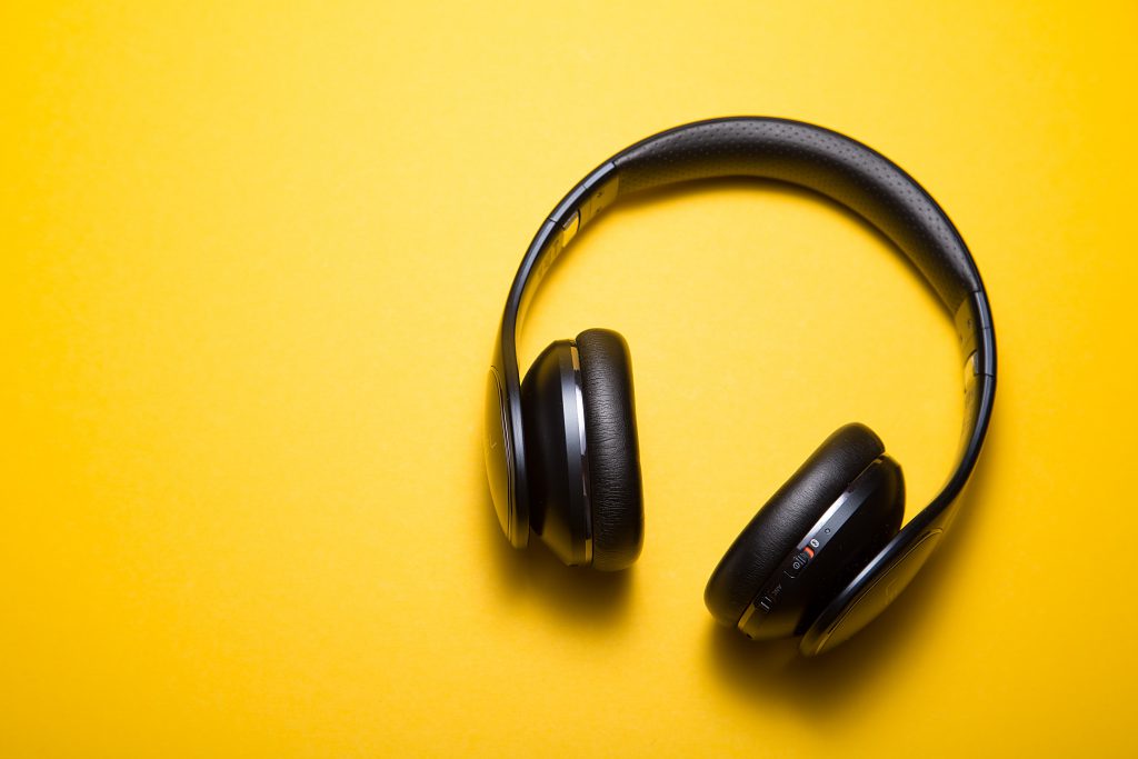 A pair of headphones on a yellow background