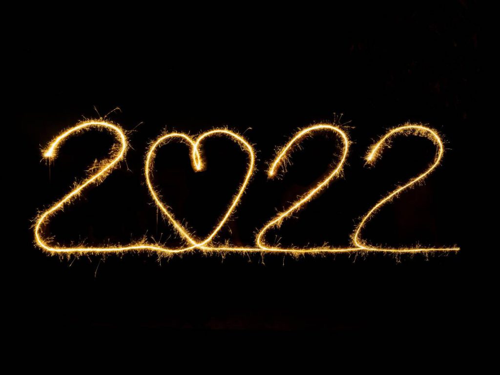 2022 spelled out in the air using a sparkler with a heart for the 0