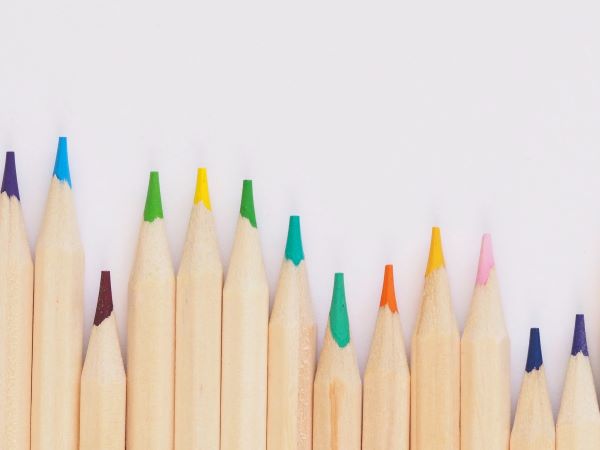 A row of colored pencils on a white background