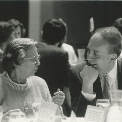 Shirley G. Moore and Rich Weinberg converse at a banquet table