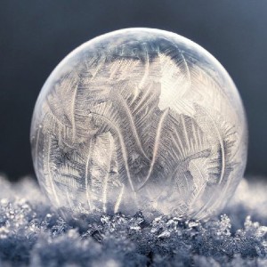 A frozen soap bubble covered with frost patterns