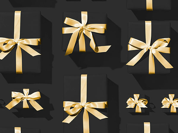 Gifts wrapped in black paper with gold bows against a black background